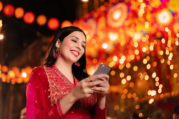 A stylish woman beside vibrant slot machines displaying glowing sevens, showcasing the variety of top slots at GB44.