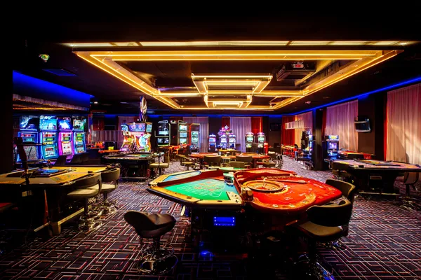 A player using their smartphone during a festive local event, representing GB44’s fully mobile-friendly casino.